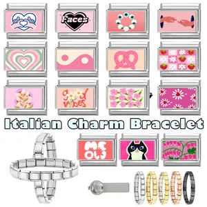 Macro view of modular pink Italian charms with heart, flower, and strawberry motifs