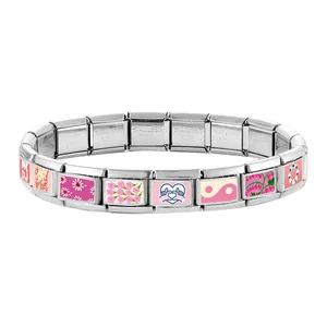Detail of Italian charm bracelet links showing stainless steel stamps and enamel art