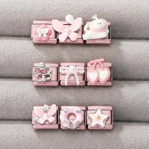 Macro detail of pink enamel charms and stainless steel modular bracelet links