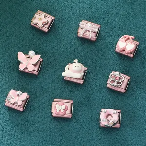 Italian modular charms with pink cat, butterfly and cherry designs on dark background