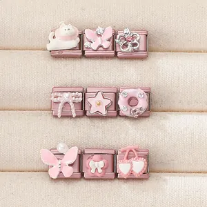 Detail of pink and rose gold Italian charms with enamel butterfly and pearl bow elements