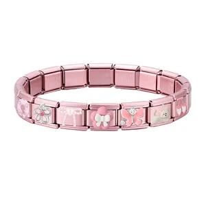 Close-up of pink modular puzzle bracelet featuring cute donut, crown, and dog charms