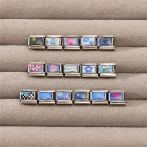 Detailed view of Italian charm links with nautical and floral patterns in a jewelry box
