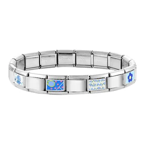 Detailed macro view of Italian charm bracelet links featuring blue floral and shell patterns