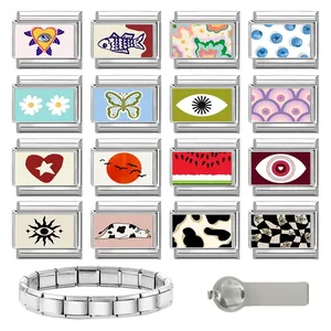 Macro view of modular Italian charms featuring colorful heart and eye motifs on steel