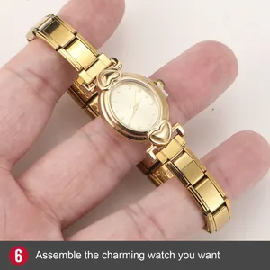 Close-up of golden fashion watch with heart motifs and modular metal strap assembly