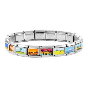 Macro detail of Italian modular charm bracelet showing stainless steel texture and scenery