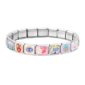Macro shot of Italian modular charm bracelet showing enamel charms and engraved links