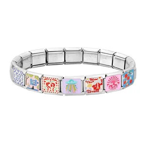 Close-up of Italian modular charm bracelet with enamel motifs and stainless steel links