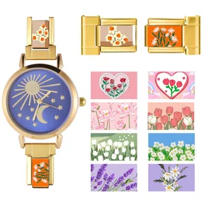 Detail of gold modular watch strap with floral links and celestial sun moon star dial