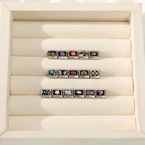 Macro detail of Italian modular charms featuring colorful floral and heart prints