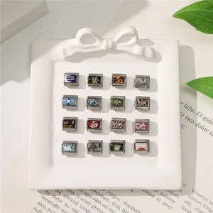 Macro view of modular Italian charm links with diverse artistic enamel painted patterns