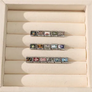Close-up of various Italian charms with floral and animal motifs in silver frames