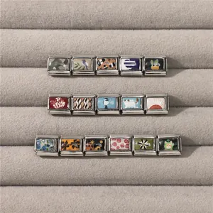 Close-up of modular Italian charms with colorful nature and animal enamel patterns