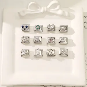 Detailed view of silver modular charms with colorful zircon butterflies and hearts