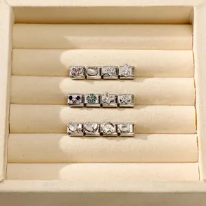 Detailed close-up of various Italian charm links with cat, heart and butterfly motifs