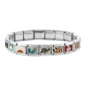 Macro view of Italian charm bracelet links with stainless steel stamp and floral art