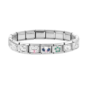 Macro detail of Italian charm bracelet links featuring a violin and heart charms in silver