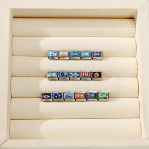 Detailed close-up of colorful enamel Italian charms with diverse patterns for DIY bracelets