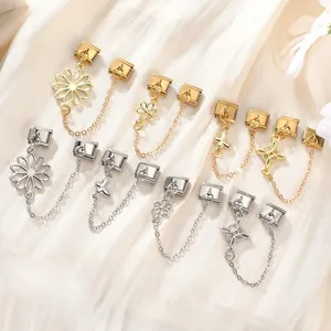 Detailed view of gold and silver Italian charm connectors with butterfly and flower patterns
