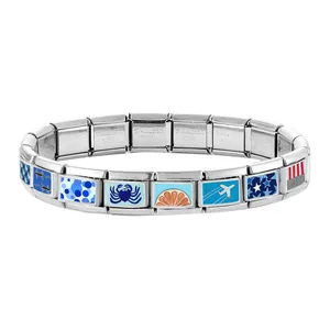 Detail showing modular Italian charm bracelet with blue gecko and crab enamel patterns