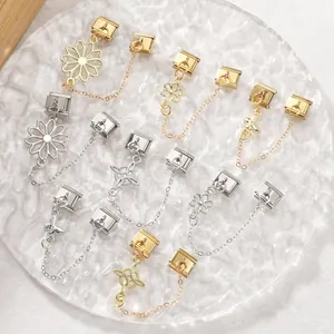 Detailed macro view of gold and silver Italian charm links with floral and butterfly charms