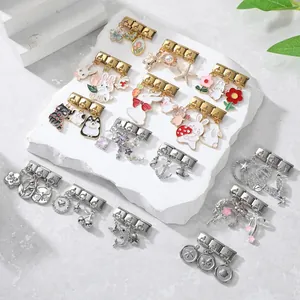 Detailed close-up of Italian modular charm links with colorful enamel pendants on stone base
