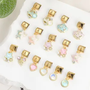 Macro detail of 15 pieces Italian charm links with gold sea shells and heart elements