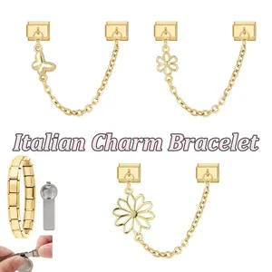 Detail of Italian charm bracelet links with gold butterfly and floral charms and assembly tool