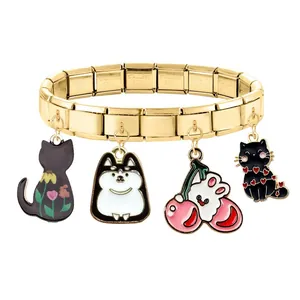 Macro view of gold stainless steel Italian charm bracelet with four cartoon pendants