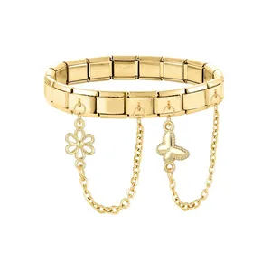 Detail of golden Italian charm bracelet featuring delicate butterfly and floral charms