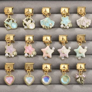 Macro view of Italian gold charms featuring stars, shells, and hearts on a velvet tray