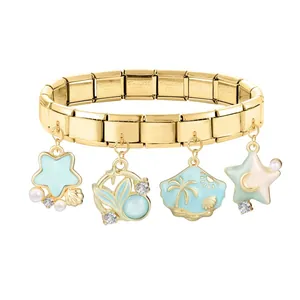 Detail of gold Italian charm bracelet showing engraved stainless steel links and shell charms