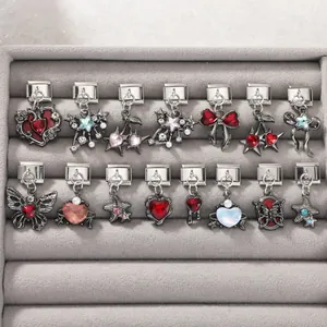 Detailed view of Italian charm links with stainless steel heart, butterfly and gem designs