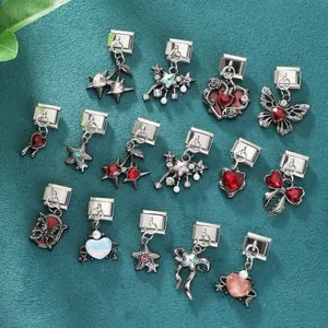Flat lay of 14 assorted Italian modular charms with hearts, stars, and butterflies