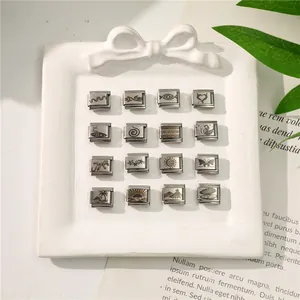 Macro view of modular stainless steel charms with shell stars and butterfly patterns