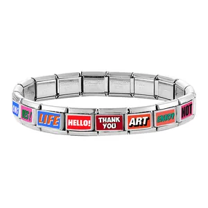 Detail of Italian modular bracelet with colorful engraved text charms in stainless steel