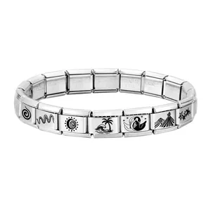 Macro view of stainless steel charm links with sun, wave, and star etched patterns