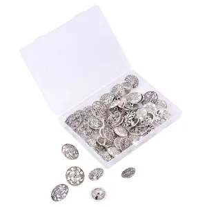 Antique silver metal flower buttons set with floral embossing in a plastic storage box