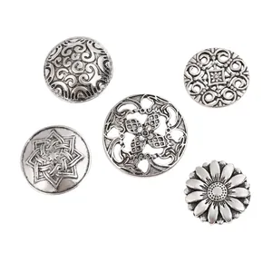 Detailed macro view of vintage silver floral metal buttons with intricate carved patterns