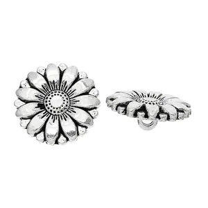 Detailed view of silver antique sunflower metal buttons with floral texture and back shank