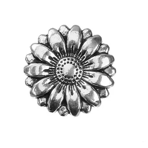 Macro shot of 18mm antique silver sunflower metal button with intricate floral petal details
