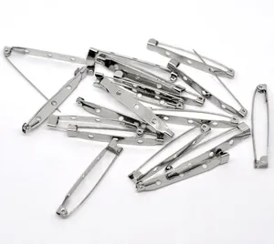 Detailed macro view of silver metal brooch safety pin bases for DIY jewelry making