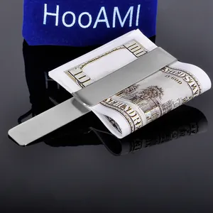 Brushed stainless steel money clip with cash and a blue velvet HooAMI gift pouch