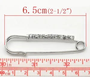 Detailed size view showing 6.5cm silver rhinestone safety pin brooch with measuring tape