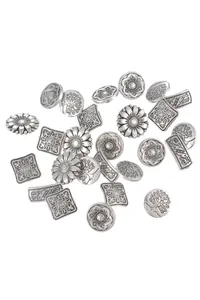 Macro shot of assorted vintage silver metal buttons with floral and mandala patterns