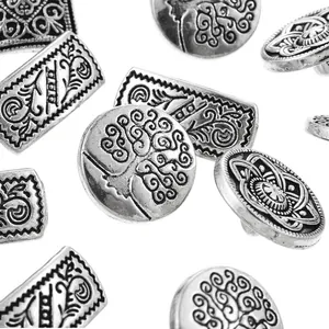 Detailed macro view of assorted vintage antique silver metal buttons with embossed patterns