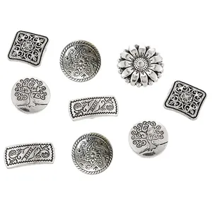 Nine mixed vintage silver metal buttons featuring tree of life and floral relief patterns