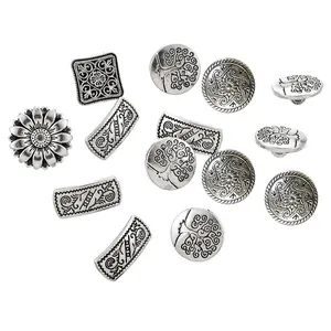 Macro shot of assorted vintage silver metal buttons with intricate floral and tree reliefs