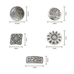 Detailed view of assorted antique silver metal buttons in mixed shapes with floral patterns